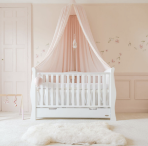 A cot in a pink room
